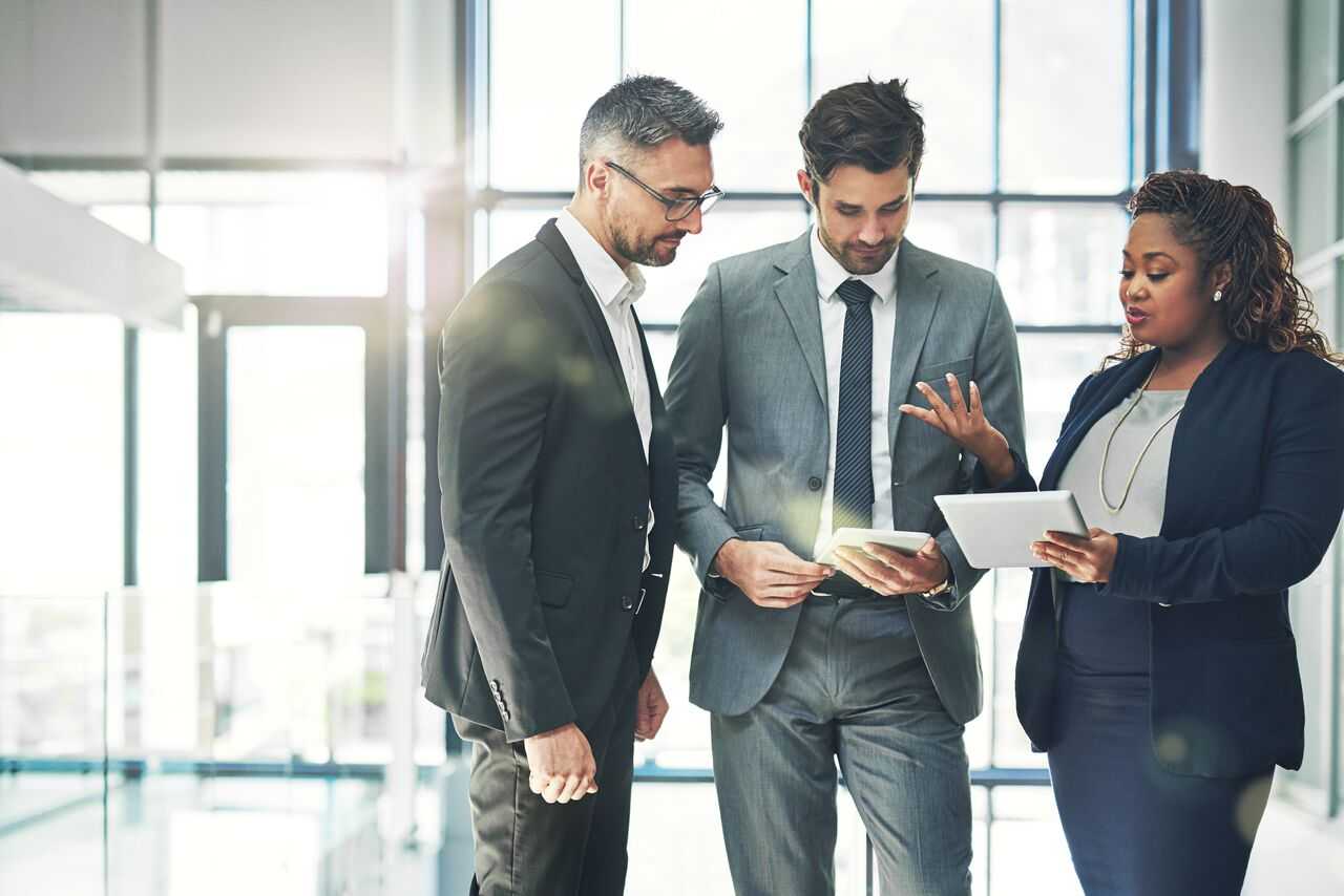 a real estate consultant discusses mergers and acquisition strategy with lawyers